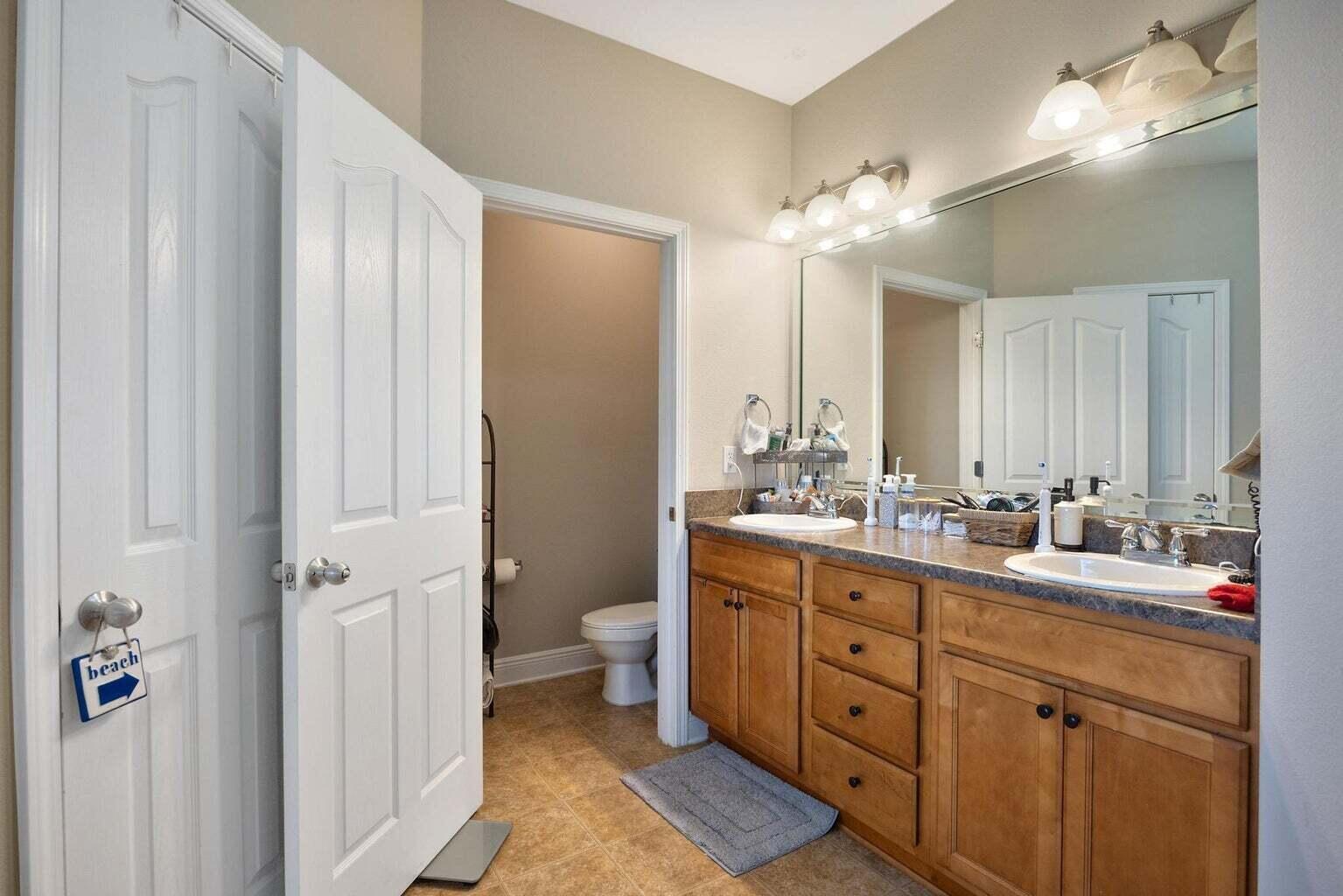 607 Rowan Circle Crestview, FL 32536 - Photo 23 of 27 a bathroom with a double vanity sink mirror and toilet