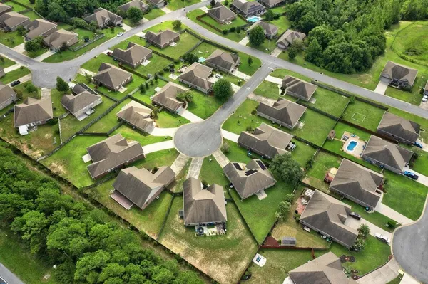 an aerial view of a house with a yard and potted plants