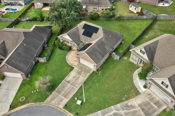 an aerial view of a house with swimming pool garden and patio