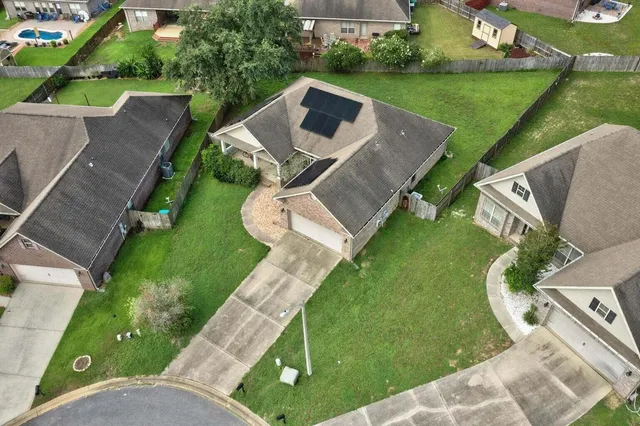 an aerial view of a house with swimming pool garden and patio