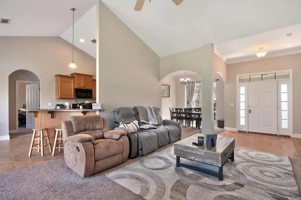 a living room with furniture and a chandelier