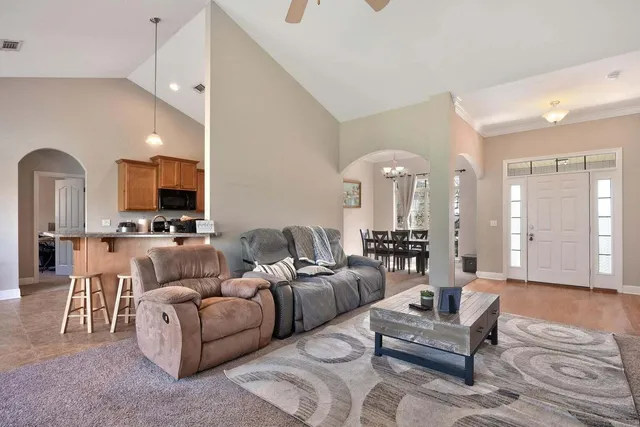 a living room with furniture and a chandelier