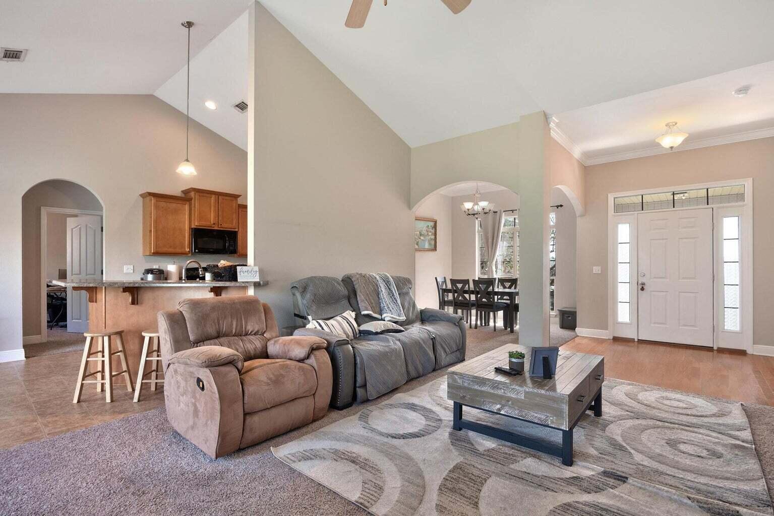 607 Rowan Circle Crestview, FL 32536 - Photo 6 of 27 a living room with furniture and a chandelier
