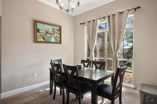 a dining room with furniture and window