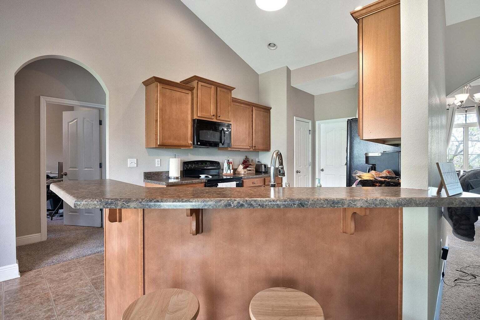 607 Rowan Circle Crestview, FL 32536 - Photo 9 of 27 a kitchen with stainless steel appliances granite countertop a sink a stove and cabinets