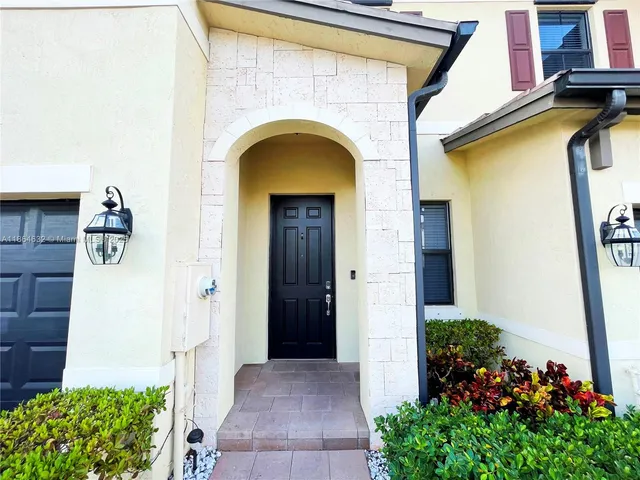 a front view of a house with flowers