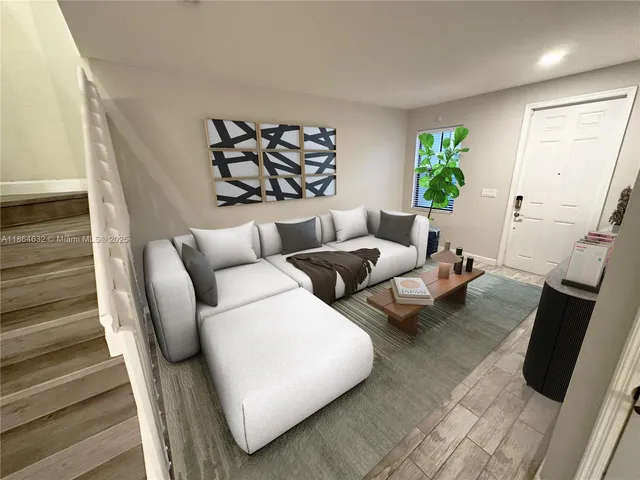 a living room with furniture and a rug