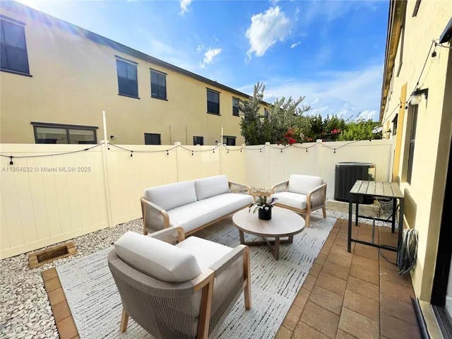 a balcony with furniture and a rug