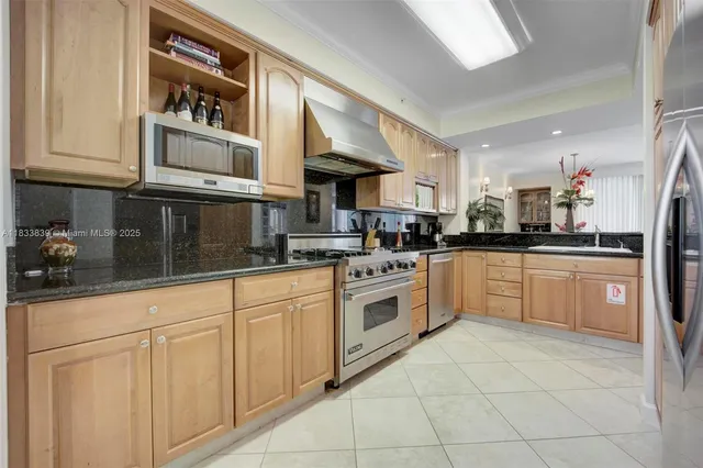 a kitchen with stainless steel appliances granite countertop a sink and cabinets