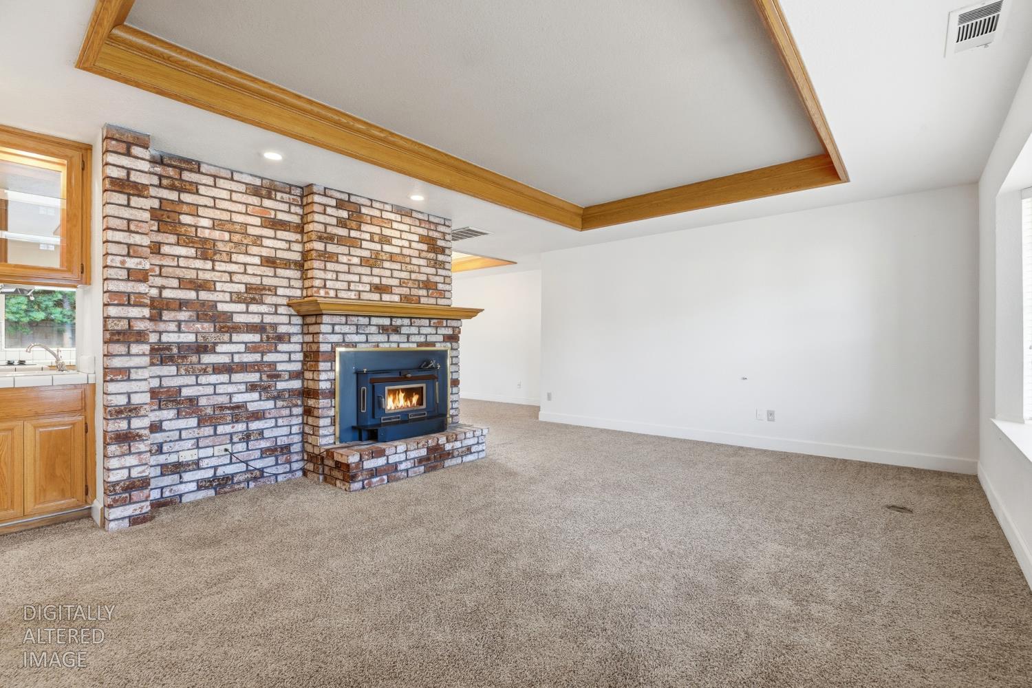 2304 Van Der Goes Way Modesto, CA 95356 - Photo 11 of 42 a view of an empty room with a fireplace