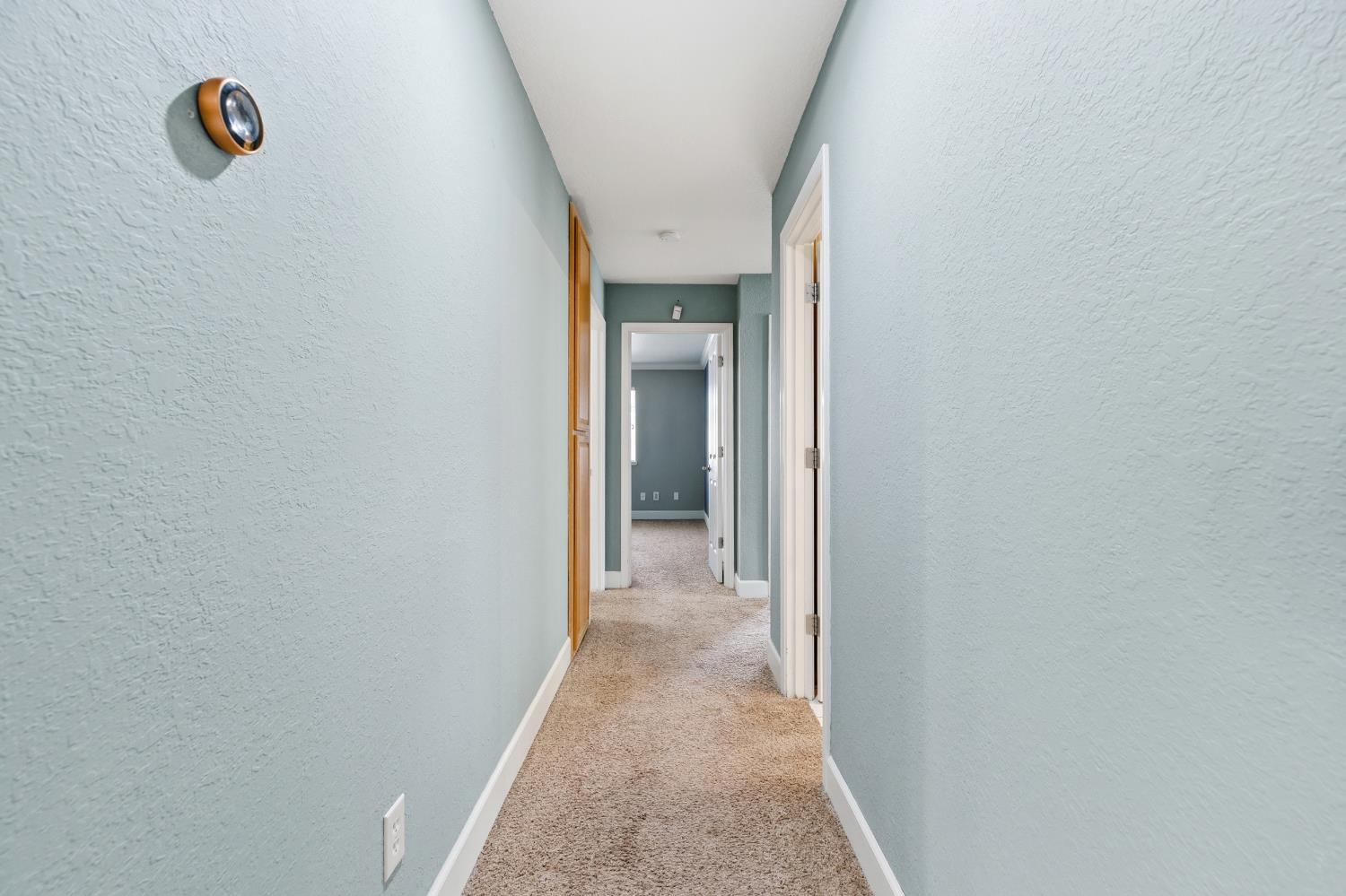 2304 Van Der Goes Way Modesto, CA 95356 - Photo 20 of 42 a view of a hallway with wooden floor