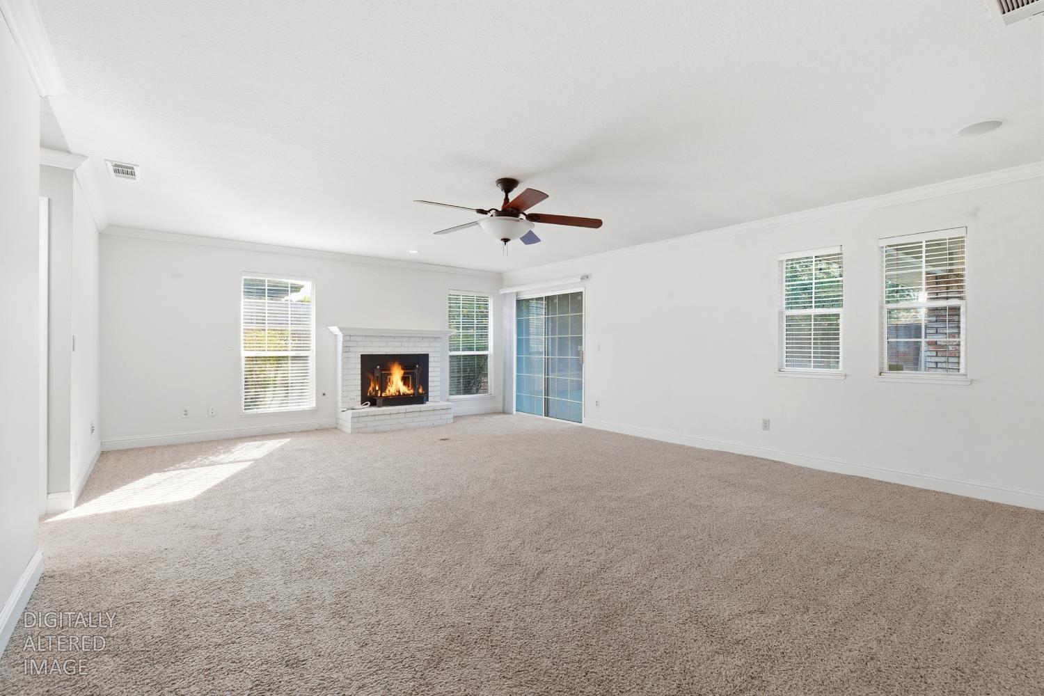 2304 Van Der Goes Way Modesto, CA 95356 - Photo 25 of 42 a view of an empty room with a fireplace and a window