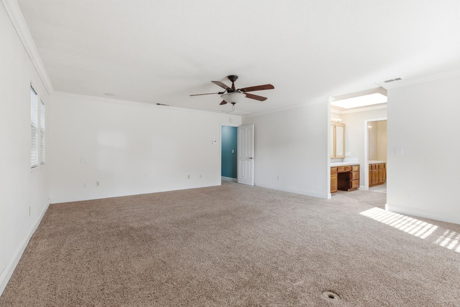 2304 Van Der Goes Way Modesto, CA 95356 - Photo 26 of 42 an empty room with a ceiling fan and a window