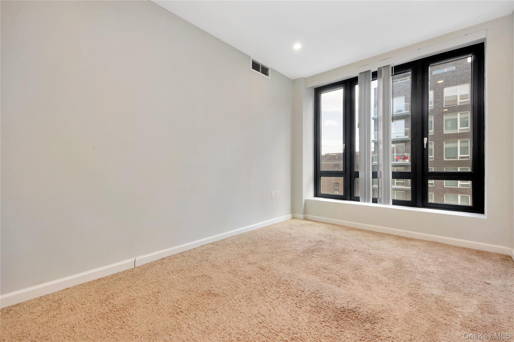 148-36 89th Avenue, Unit 204 Queens, NY 11435 - Photo 11 of 32 a view of an empty room with a window