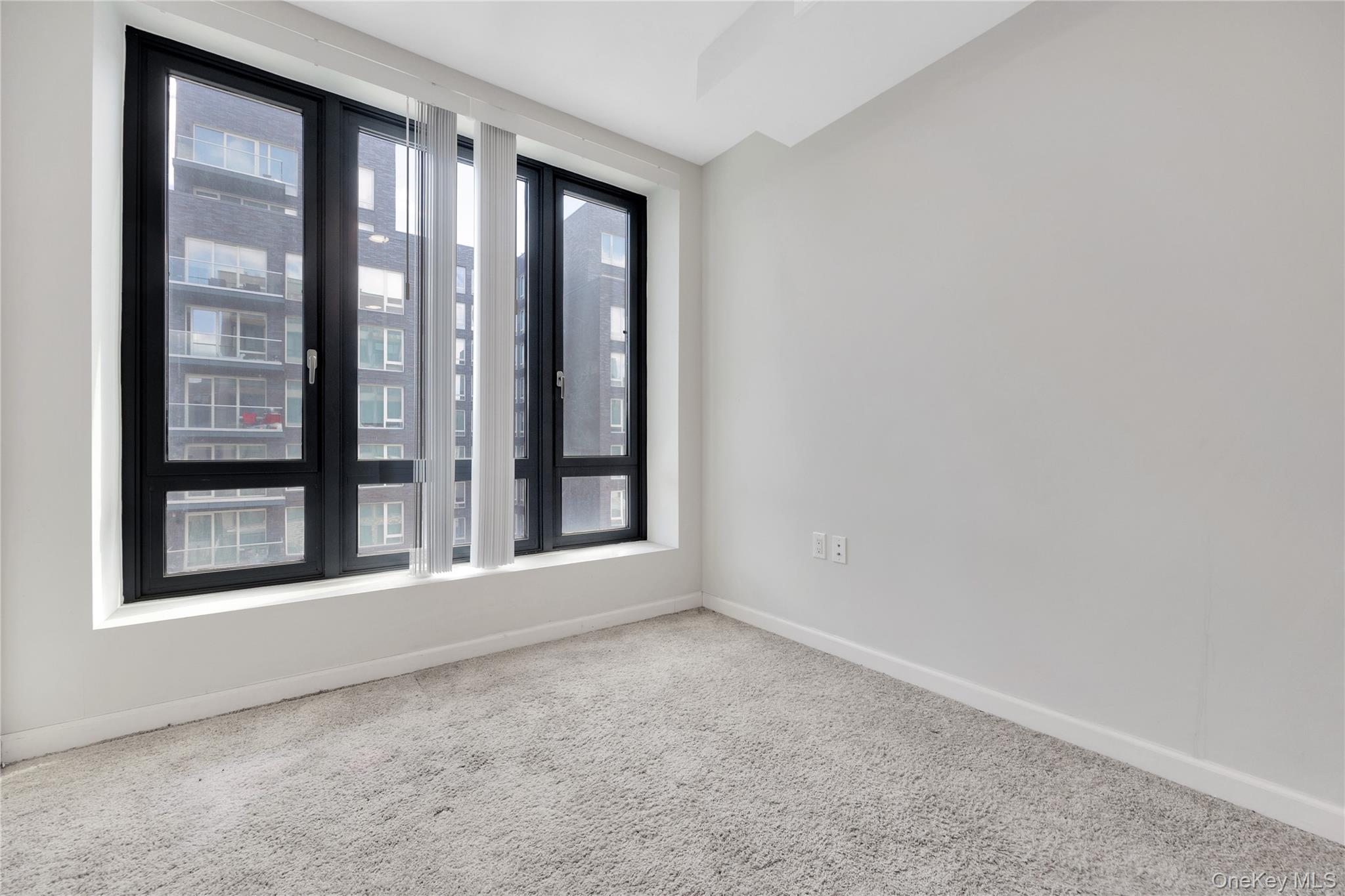 148-36 89th Avenue, Unit 204 Queens, NY 11435 - Photo 13 of 32 an empty room with a large window