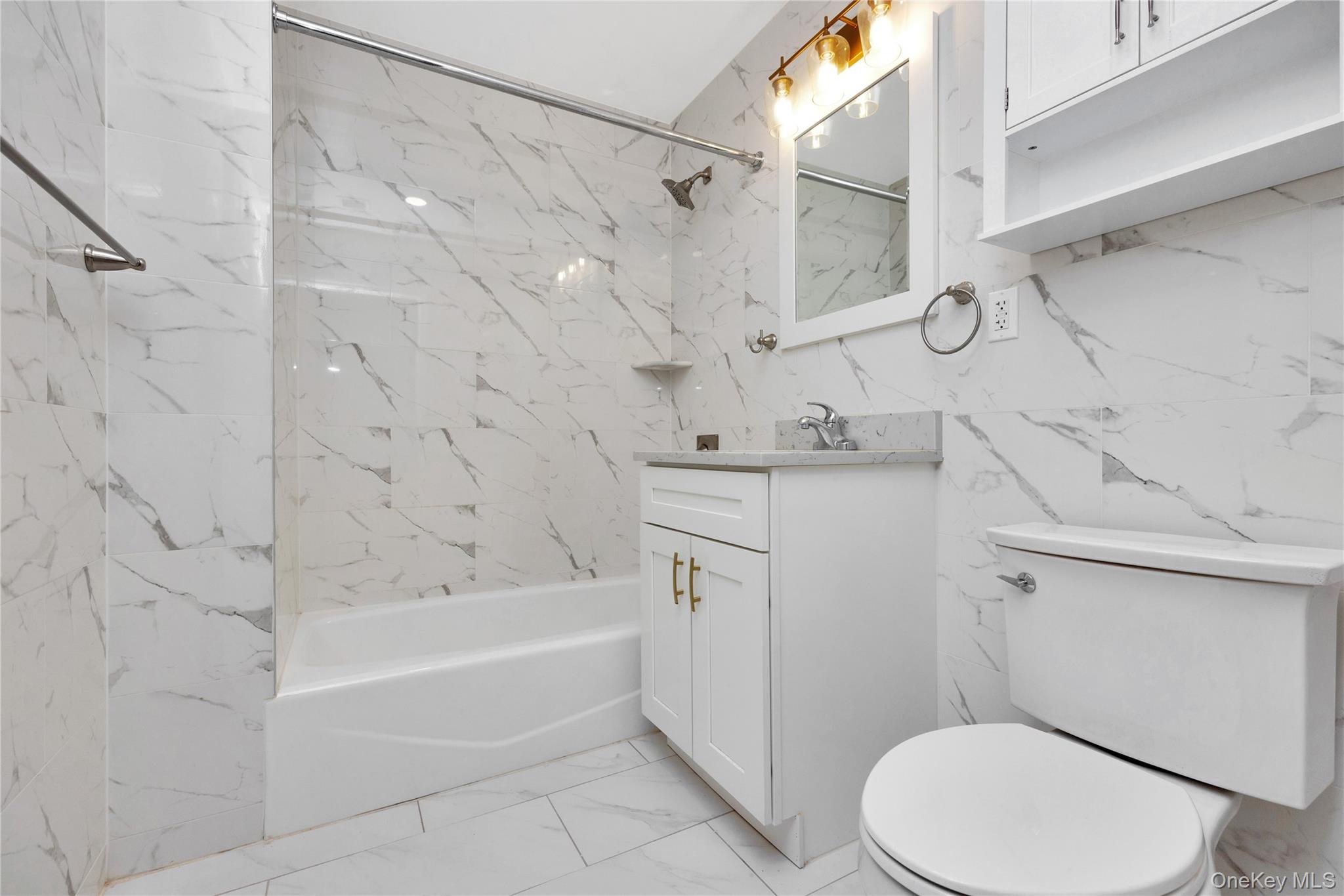 148-36 89th Avenue, Unit 204 Queens, NY 11435 - Photo 17 of 32 a bathroom with a sink a toilet and shower