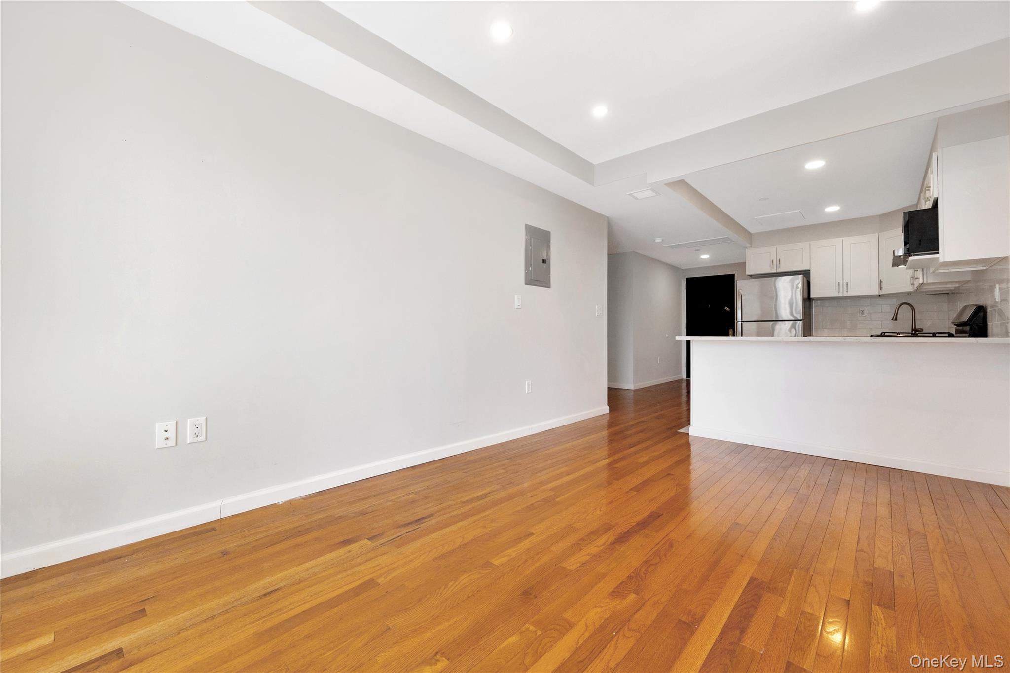 148-36 89th Avenue, Unit 204 Queens, NY 11435 - Photo 20 of 32 a view of kitchen with wooden floor and electronic appliances