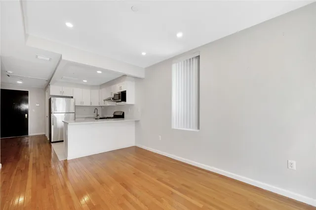 a view of kitchen with wooden floor