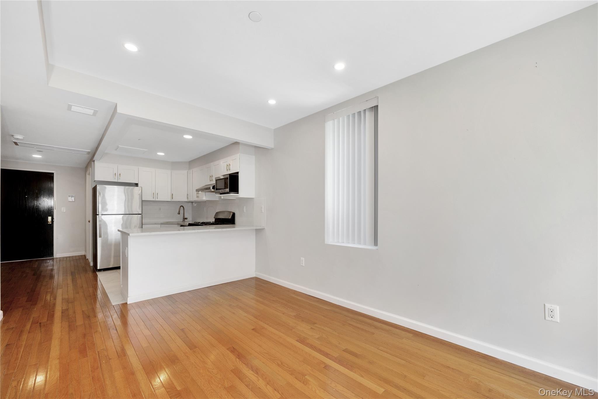 148-36 89th Avenue, Unit 204 Queens, NY 11435 - Photo 21 of 32 a view of kitchen with wooden floor