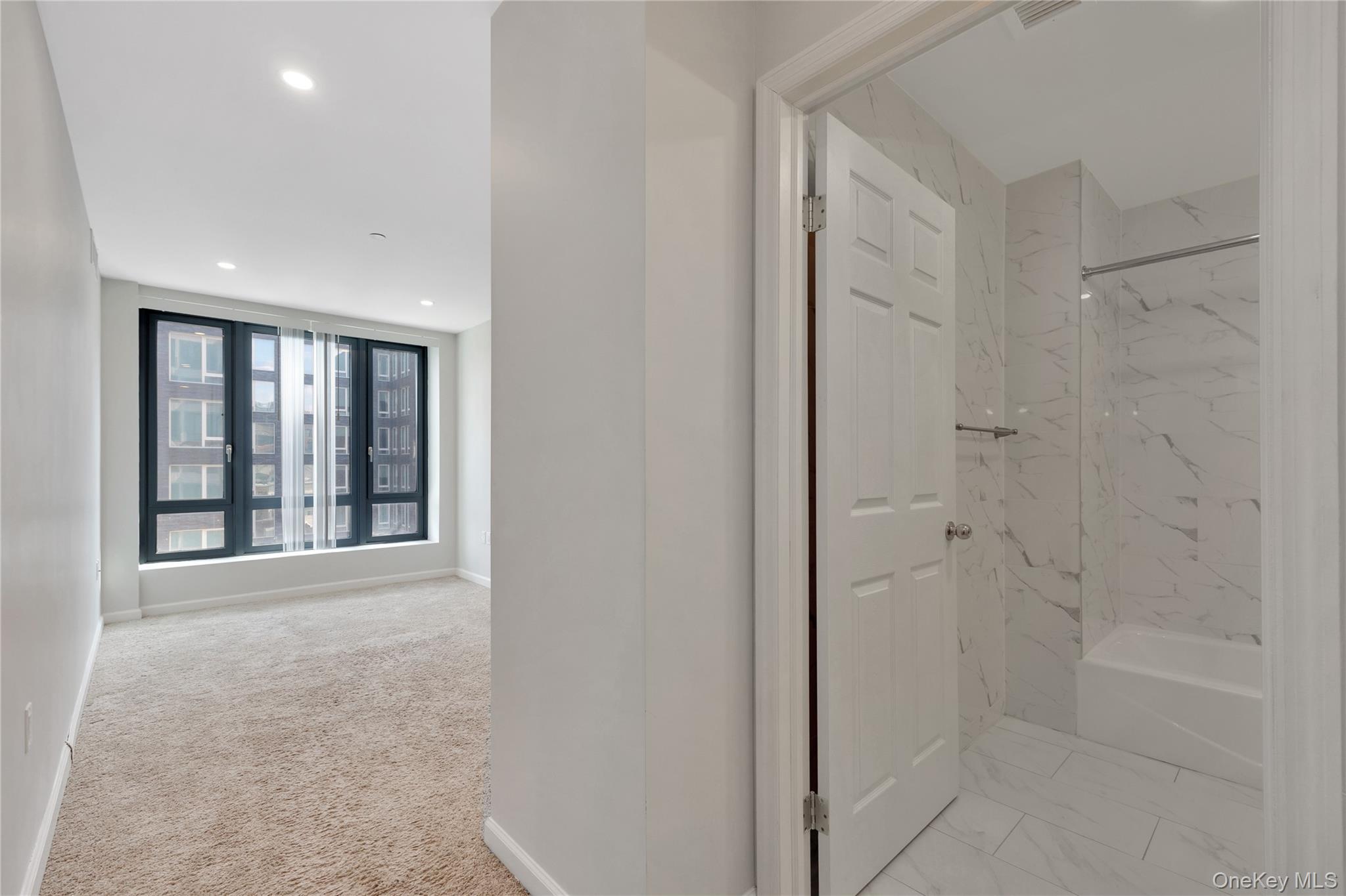 148-36 89th Avenue, Unit 204 Queens, NY 11435 - Photo 7 of 32 a view of an empty room with a window