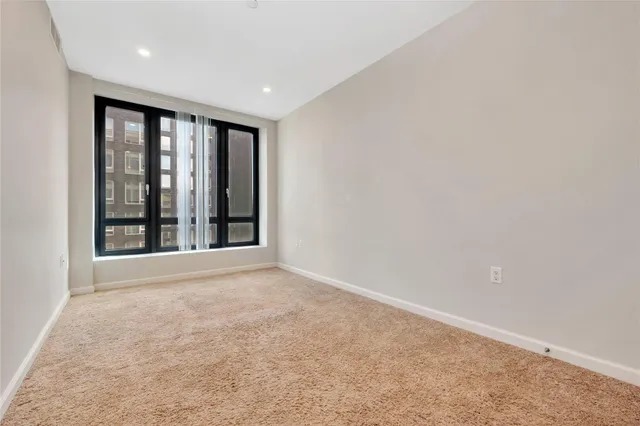 an empty room with large windows