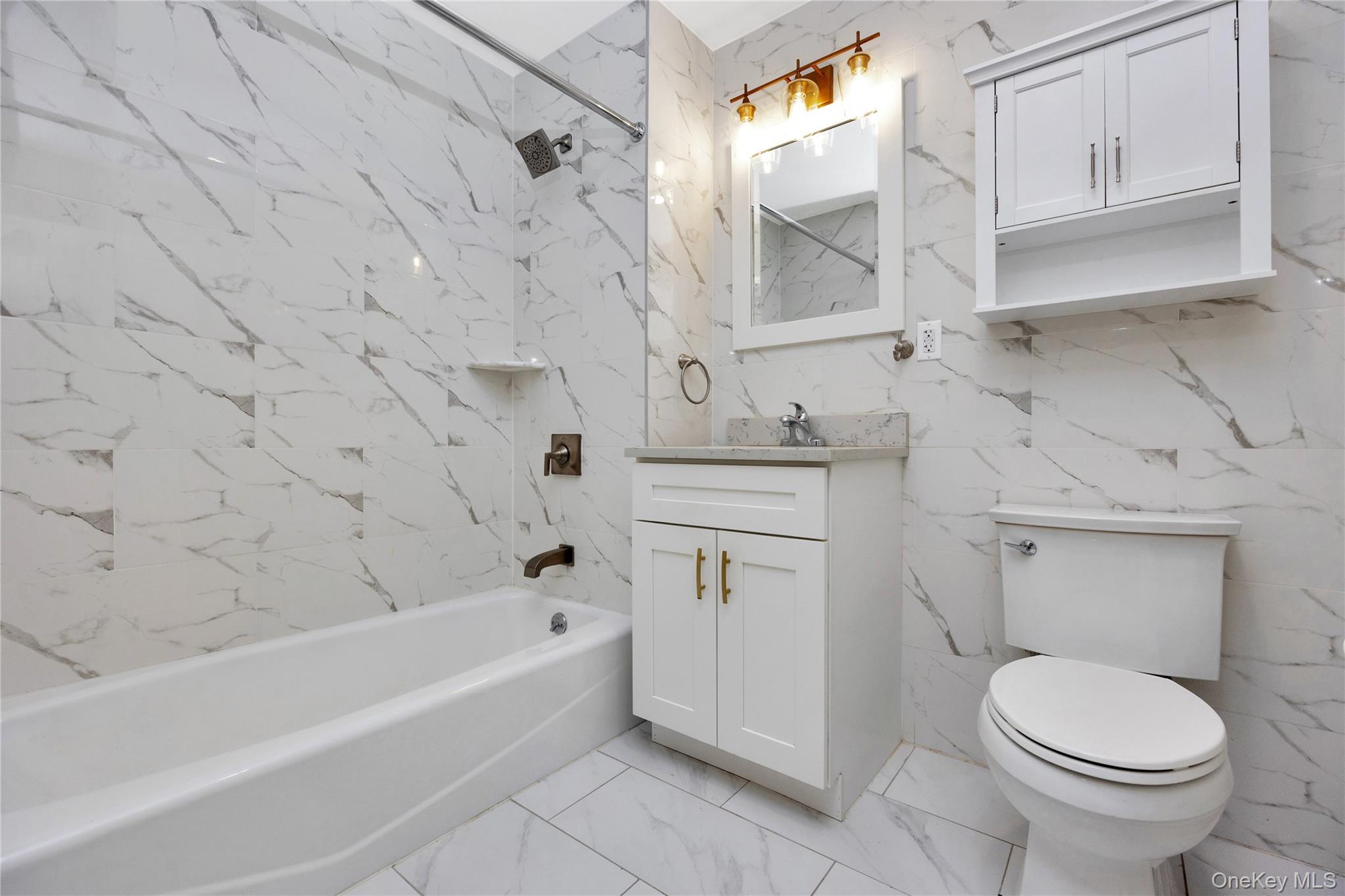 148-36 89th Avenue, Unit 204 Queens, NY 11435 - Photo 10 of 32 a bathroom with a sink toilet and bathtub