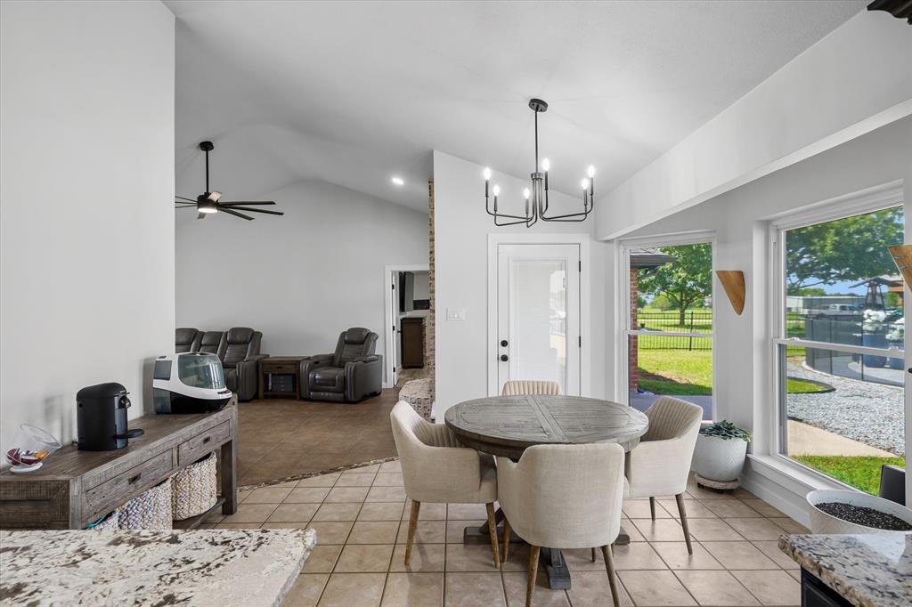 9346 Homestead Lane Forney, TX 75126 - Photo 11 of 39 The dining area serves as a transition from the living room to the kitchen and provides a nice view of the pool area outside.