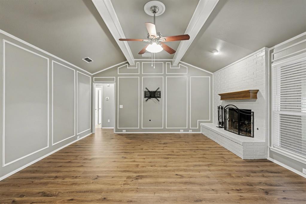 908 Thoreau Lane Allen, TX 75002 - Photo 13 of 31 a view of an empty room with a fireplace and a window