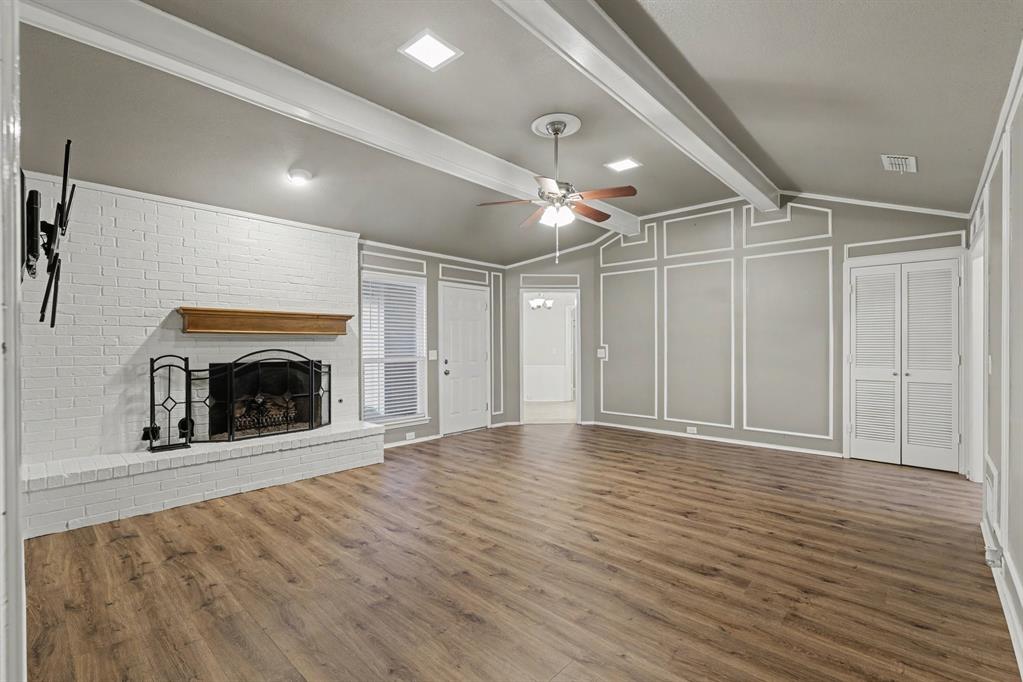 908 Thoreau Lane Allen, TX 75002 - Photo 14 of 31 a view of an empty room with wooden floor fireplace and a window