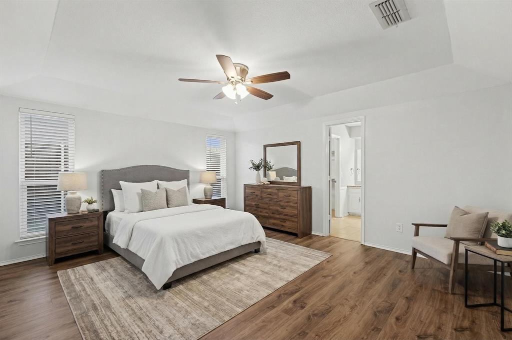 908 Thoreau Lane Allen, TX 75002 - Photo 15 of 31 a bedroom with a bed and a table in it