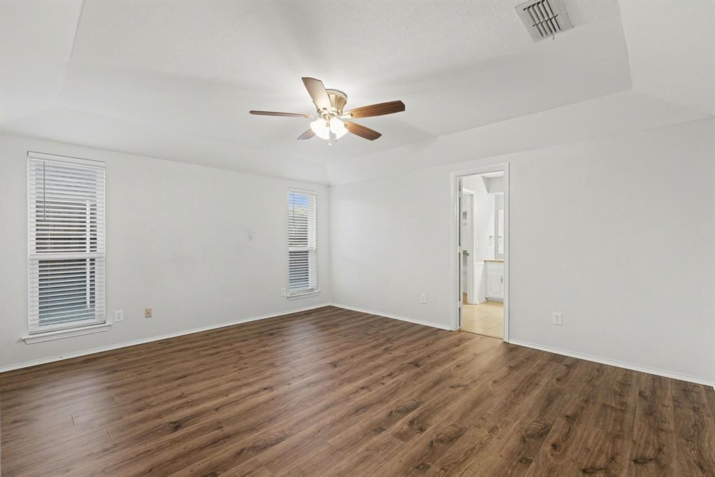 908 Thoreau Lane Allen, TX 75002 - Photo 16 of 31 wooden floor in an empty room with a window