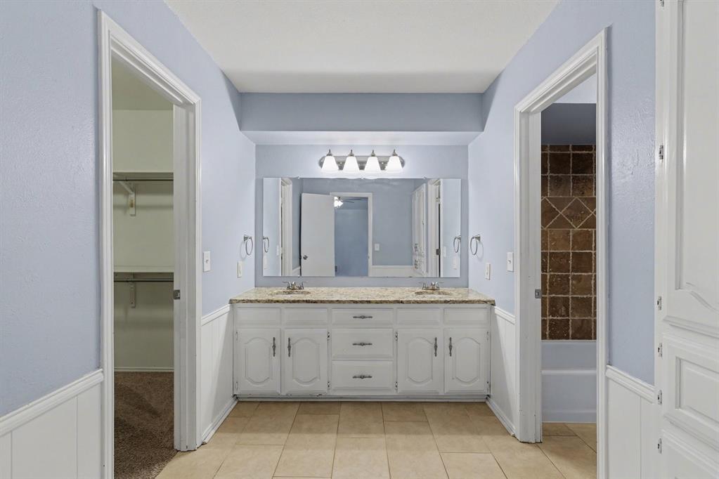 908 Thoreau Lane Allen, TX 75002 - Photo 17 of 31 a bathroom with a granite countertop sink a large mirror and a shower