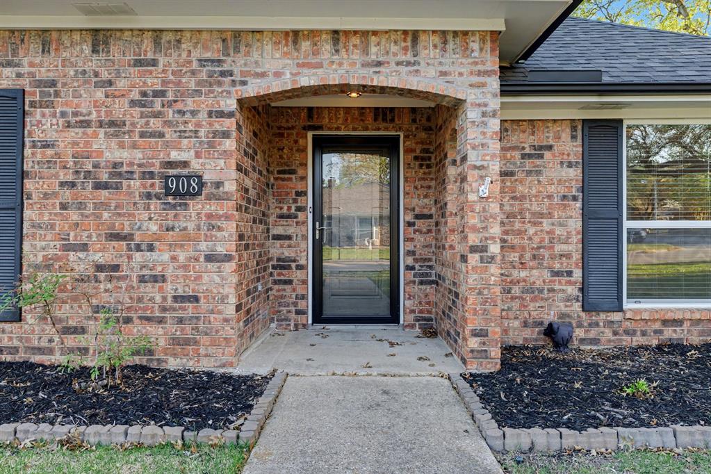908 Thoreau Lane Allen, TX 75002 - Photo 2 of 31 a front view of a house with a garden