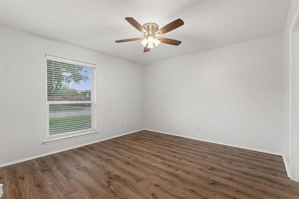908 Thoreau Lane Allen, TX 75002 - Photo 21 of 31 wooden floor in an empty room with a window
