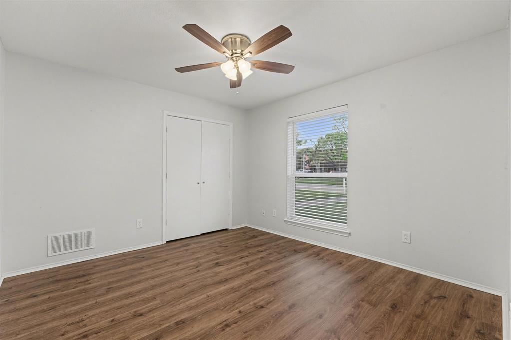 908 Thoreau Lane Allen, TX 75002 - Photo 24 of 31 a view of an empty room with wooden floor and a window