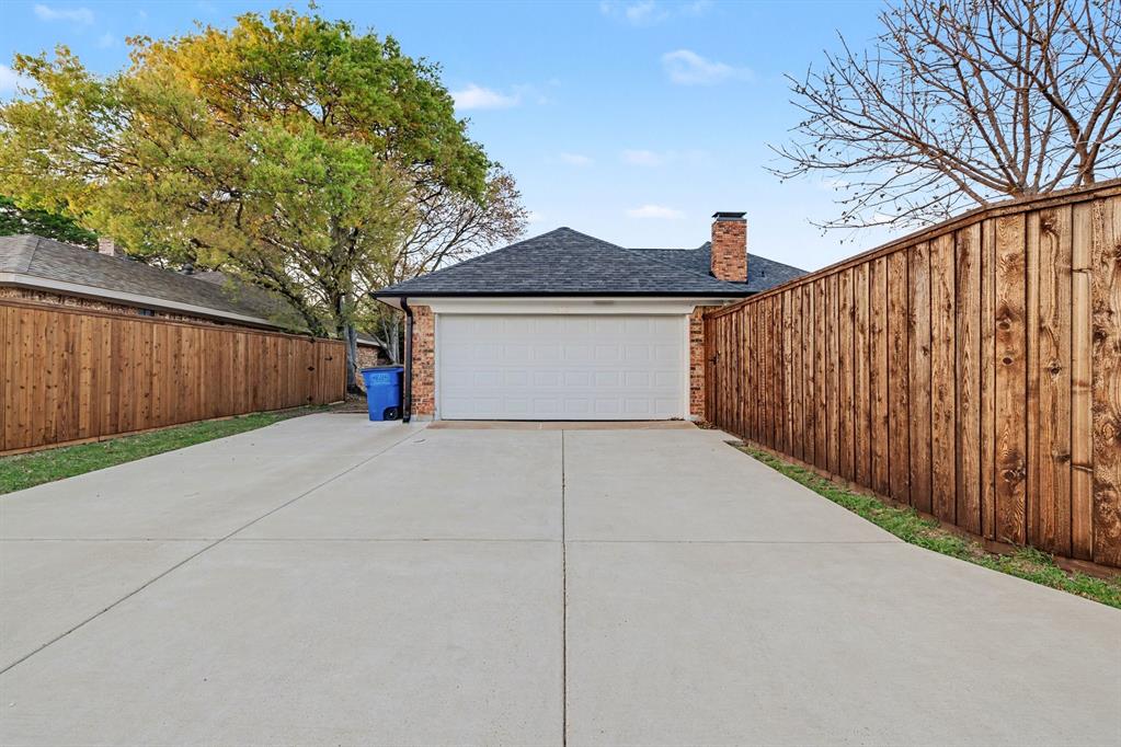 908 Thoreau Lane Allen, TX 75002 - Photo 29 of 31 a view of garage and wooden fence