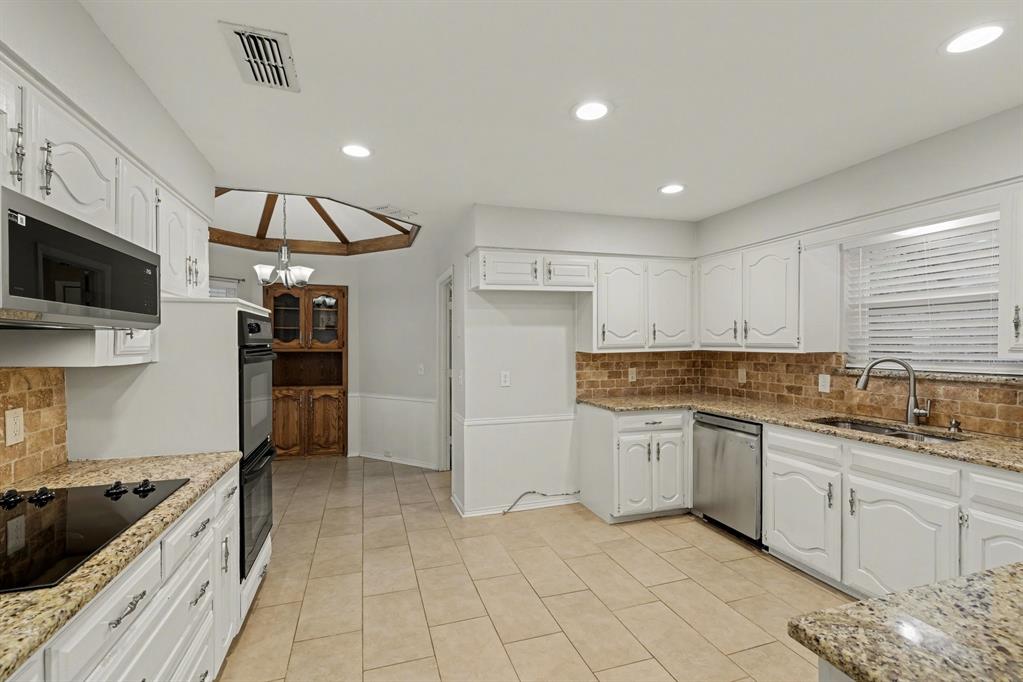 908 Thoreau Lane Allen, TX 75002 - Photo 7 of 31 a kitchen with a sink stainless steel appliances and cabinets