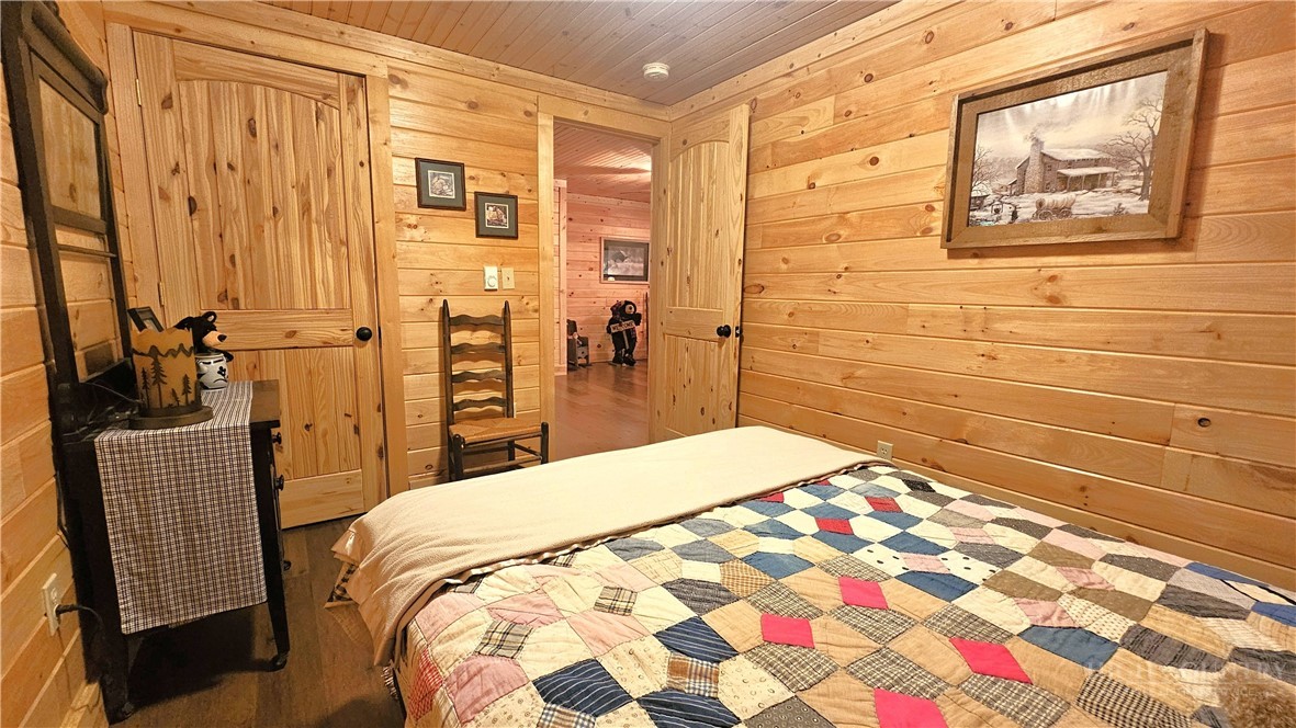 3043 Junaluska Road Boone, NC 28607 - Photo 35 of 49 a bedroom with a bed and a mirror