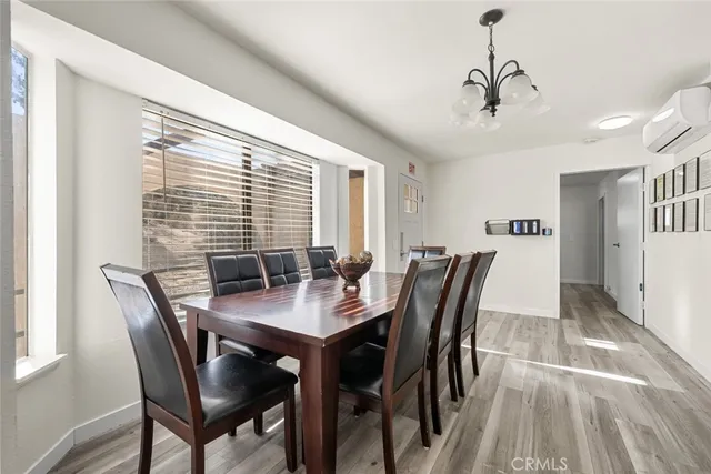 a spacious bedroom with a bed and chandelier