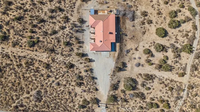 a spacious bedroom with a bed a couch and a window