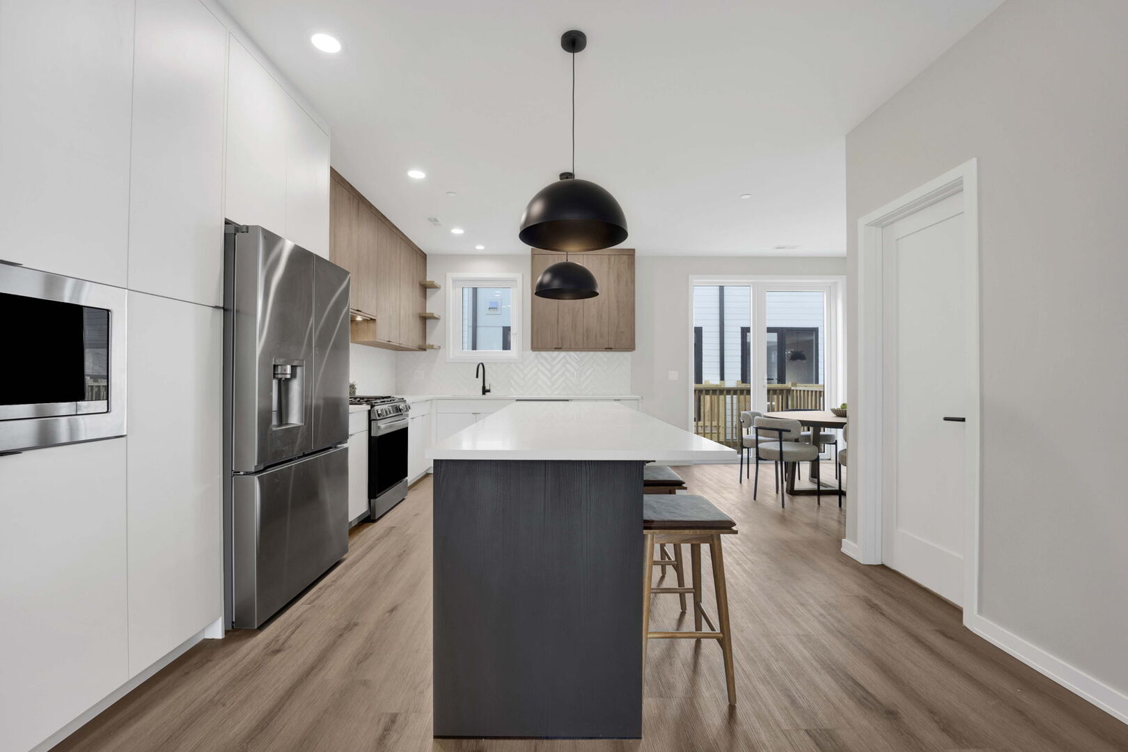 944 Beloit Avenue, Unit 2 Forest Park, IL 60130 - Photo 11 of 32 a kitchen with stainless steel appliances a kitchen island hardwood floor sink stove dining table and chairs