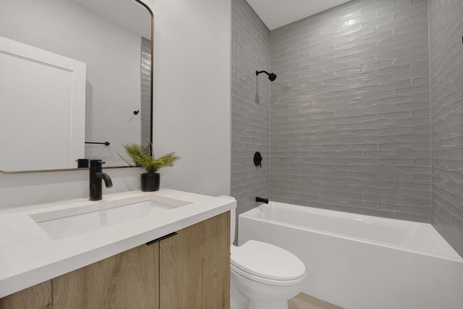 944 Beloit Avenue, Unit 2 Forest Park, IL 60130 - Photo 26 of 32 a bathroom with a sink a toilet and a bathtub