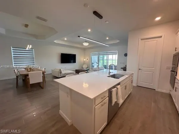 a large white room with a large bed and a flat screen tv