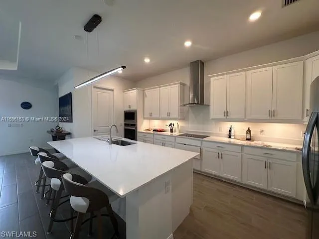 a kitchen with kitchen island a sink table and chairs