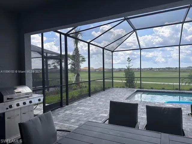 a living room with furniture and floor to ceiling windows