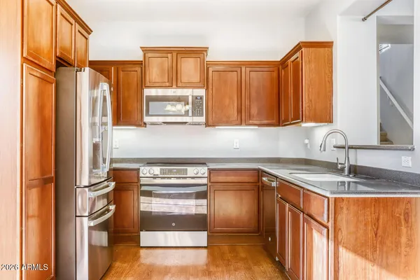 a view of an empty room with window and chandelier