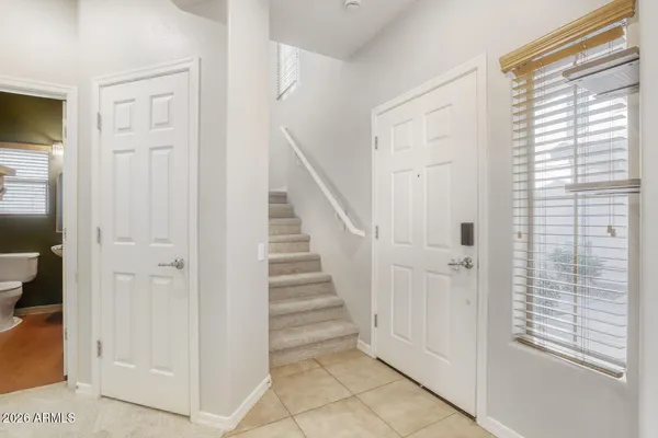 a bathroom with a sink a vanity a lamp and a mirror