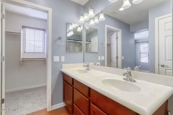 a view of a big room with closet and a chandelier fan