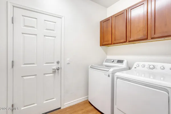 an empty room with chandelier fan