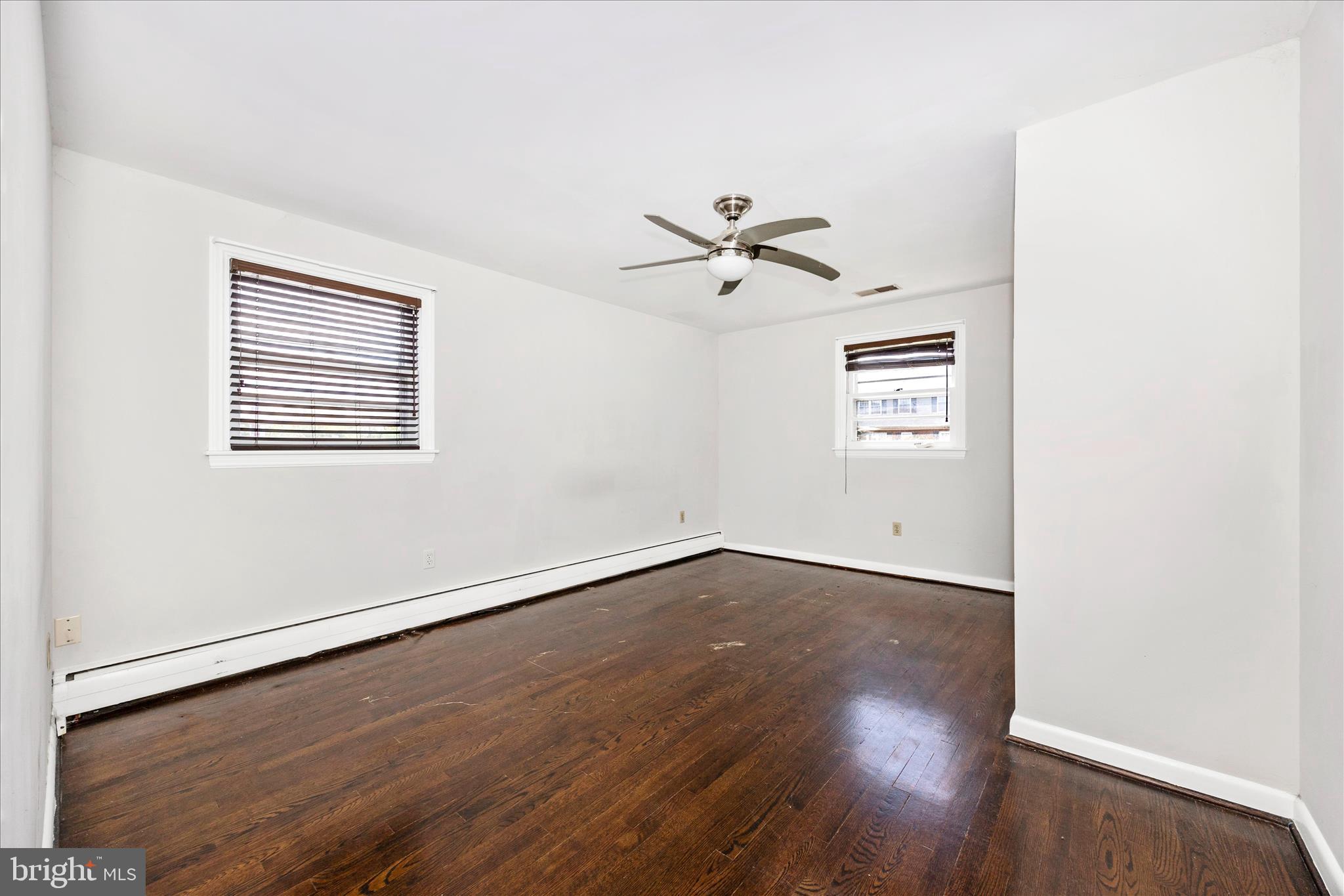 17 East 13th Street Frederick, MD 21701 - Photo 19 of 53 an empty room with wooden floor and windows